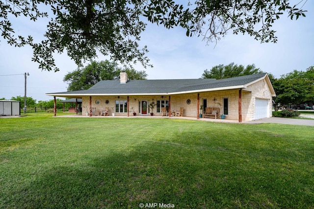 1302 County Road 142, Ovalo, TX 79541 - view of front of home with stone siding, a front lawn, driveway, an attached garage, and a chimney