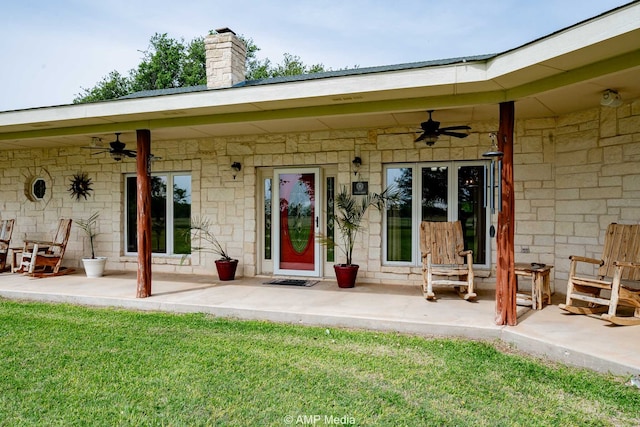 1302 County Road 142, Ovalo, TX 79541 - entrance to property featuring a ceiling fan, a chimney, stone siding, and a yard
