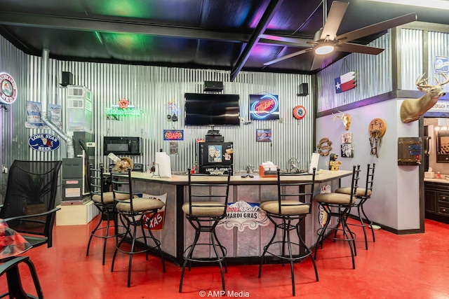 1302 County Road 142, Ovalo, TX 79541 - indoor bar featuring finished concrete floors, ceiling fan, and black microwave