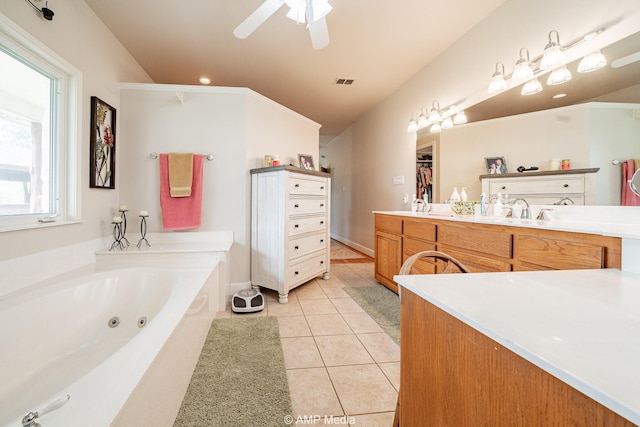 1302 County Road 142, Ovalo, TX 79541 - full bath featuring tile patterned floors, a whirlpool tub, vaulted ceiling, ceiling fan, and a walk in closet