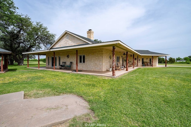 1302 County Road 142, Ovalo, TX 79541 - back of house featuring a chimney, a lawn, stone siding, and a patio
