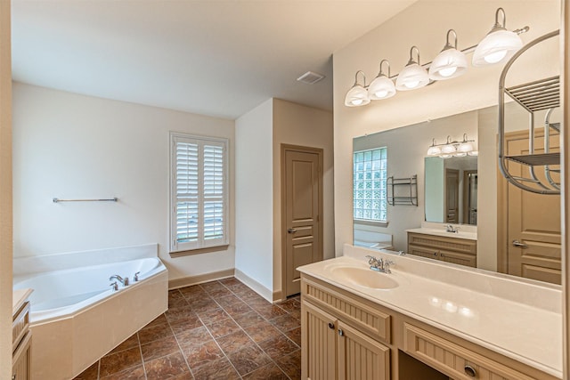 15097 Blakehill Dr, Frisco, TX 75035 - full bathroom with healthy amount of natural light, a garden tub, vanity, and baseboards