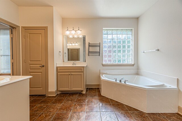 15097 Blakehill Dr, Frisco, TX 75035 - bathroom featuring vanity, a garden tub, and baseboards