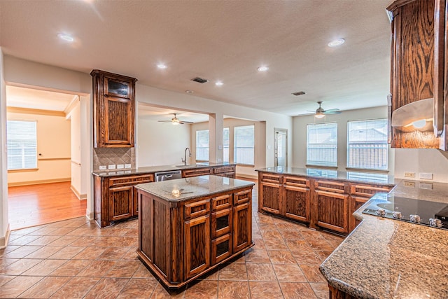 15097 Blakehill Dr, Frisco, TX 75035 - kitchen with a ceiling fan, a peninsula, black electric stovetop, recessed lighting, and a textured ceiling