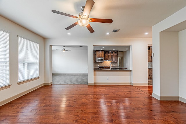 15097 Blakehill Dr, Frisco, TX 75035 - unfurnished living room featuring hardwood / wood-style flooring, ceiling fan, recessed lighting, a sink, and baseboards