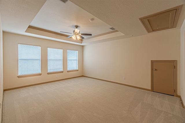 15097 Blakehill Dr, Frisco, TX 75035 - empty room with attic access, light carpet, a tray ceiling, ceiling fan, and baseboards