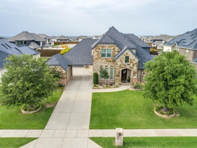 1141 Saint Peter Ln, Prosper, TX 75078 - french country style house with stone siding, driveway, a residential view, and a front lawn