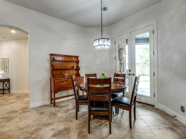 1141 Saint Peter Ln, Prosper, TX 75078 - dining area with arched walkways, french doors, and a chandelier