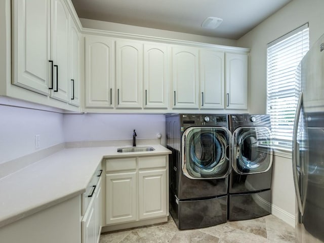 1141 Saint Peter Ln, Prosper, TX 75078 - washroom featuring cabinet space, washing machine and clothes dryer, and light stone finish floors