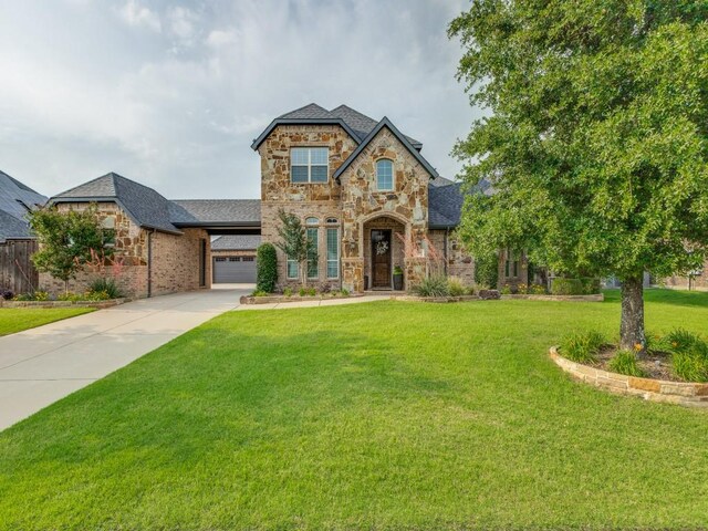 1141 Saint Peter Ln, Prosper, TX 75078 - view of front of property featuring stone siding, concrete driveway, a front lawn, an attached garage, and brick siding