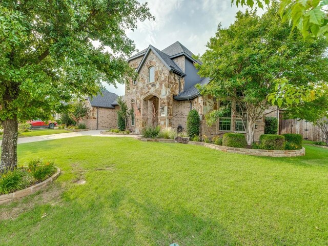 1141 Saint Peter Ln, Prosper, TX 75078 - french country inspired facade featuring stone siding and brick siding