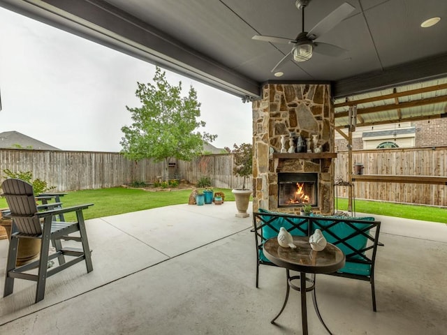 1141 Saint Peter Ln, Prosper, TX 75078 - fenced backyard with an outdoor stone fireplace, a patio area, and ceiling fan