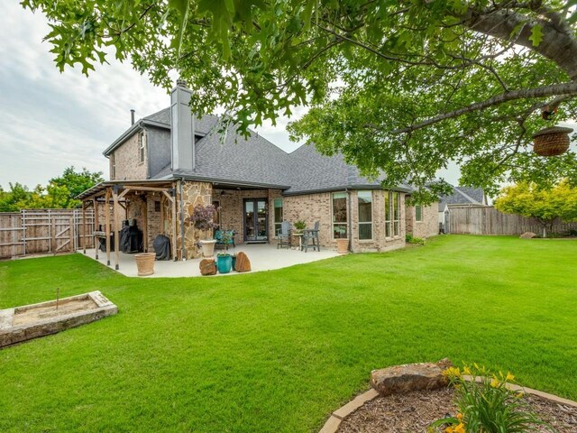 1141 Saint Peter Ln, Prosper, TX 75078 - back of property with a patio area, roof with shingles, a fenced backyard, a chimney, and brick siding