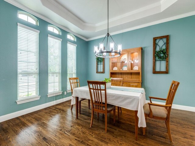 1141 Saint Peter Ln, Prosper, TX 75078 - dining area featuring a raised ceiling, dark wood-style flooring, a chandelier, plenty of natural light, and crown molding