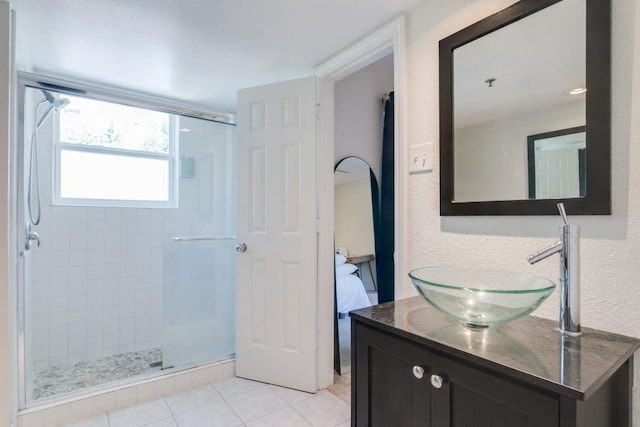 3100 Cole Ave Unit 203, Dallas, TX 75204 - ensuite bathroom with a stall shower, tile patterned floors, and vanity