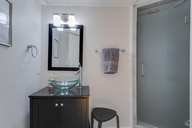 3100 Cole Ave Unit 203, Dallas, TX 75204 - bathroom featuring a stall shower and vanity
