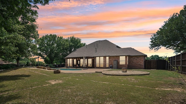 6000 Windridge Ln, Flower Mound, TX 75028 - back of property at dusk featuring brick siding and a patio area