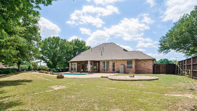 6000 Windridge Ln, Flower Mound, TX 75028 - rear view of property with brick siding, a patio, an outdoor pool, and roof with shingles