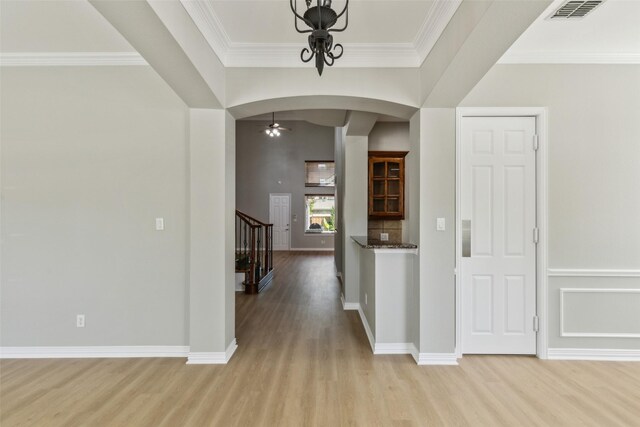 1968 Crowbridge Dr, Frisco, TX 75033 - foyer with arched walkways, light wood-style floors, stairway, ornamental molding, and baseboards