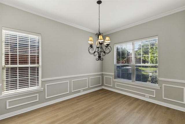 1968 Crowbridge Dr, Frisco, TX 75033 - unfurnished dining area with a chandelier, wood finished floors, ornamental molding, wainscoting, and a decorative wall