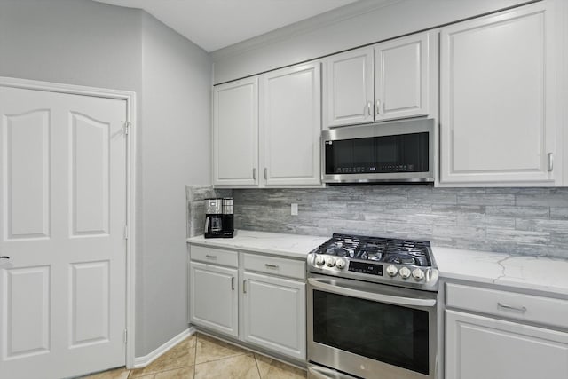 6600 Stewart Blvd, The Colony, TX 75056 - kitchen with stainless steel appliances, tasteful backsplash, white cabinets, and light stone counters