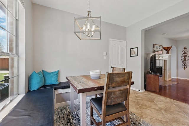 6600 Stewart Blvd, The Colony, TX 75056 - dining room featuring a chandelier, a fireplace, and baseboards