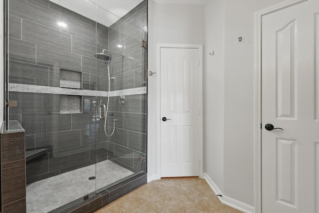6600 Stewart Blvd, The Colony, TX 75056 - bathroom with a stall shower, baseboards, and tile patterned floors