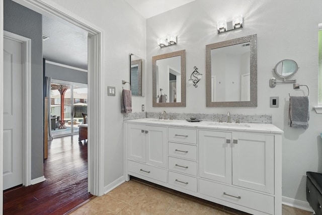 6600 Stewart Blvd, The Colony, TX 75056 - full bathroom with double vanity, baseboards, and wood finished floors