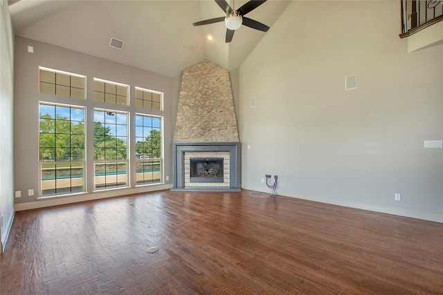 188 Las Colinas Trl, Cross Roads, TX 76227 - unfurnished living room with high vaulted ceiling, ceiling fan, wood finished floors, baseboards, and a stone fireplace