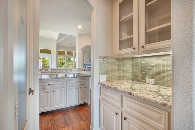 188 Las Colinas Trl, Cross Roads, TX 76227 - bar area with arched walkways, dark wood-style flooring, tasteful backsplash, and recessed lighting