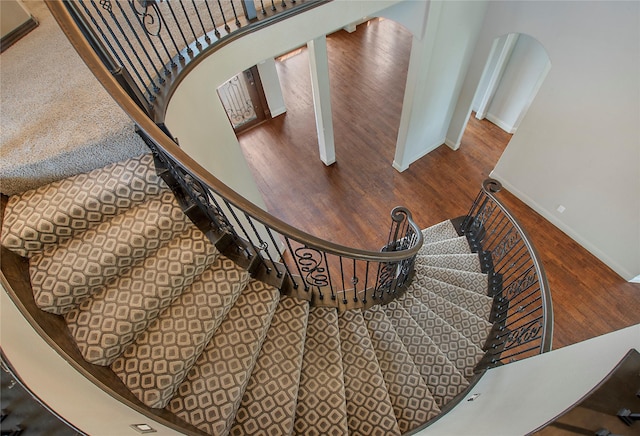 188 Las Colinas Trl, Cross Roads, TX 76227 - staircase with wood finished floors, baseboards, and arched walkways