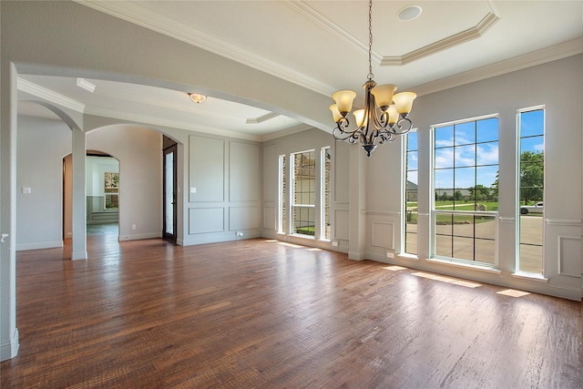 188 Las Colinas Trl, Cross Roads, TX 76227 - spare room featuring arched walkways, a decorative wall, a chandelier, wood finished floors, and ornamental molding