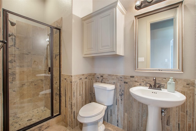 188 Las Colinas Trl, Cross Roads, TX 76227 - full bathroom featuring a stall shower, tile walls, toilet, and wainscoting