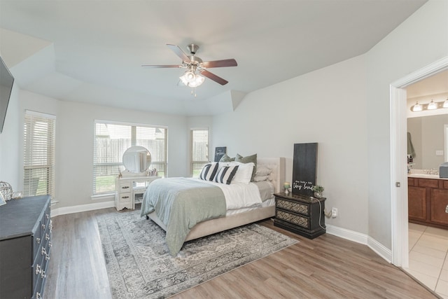 816 Kinghaven Dr, Little Elm, TX 75068 - bedroom featuring light wood-type flooring, connected bathroom, baseboards, and ceiling fan