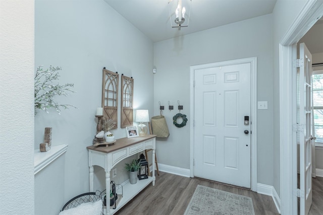 816 Kinghaven Dr, Little Elm, TX 75068 - foyer featuring wood finished floors, baseboards, and a chandelier