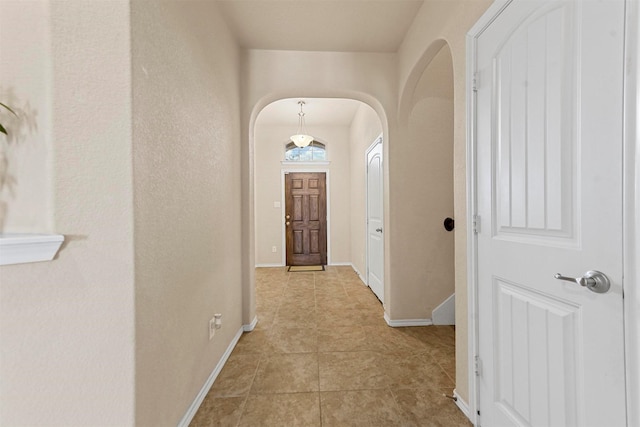 11517 Dorado Vista Trl, Fort Worth, TX 76052 - hall featuring arched walkways, light tile patterned floors, and baseboards