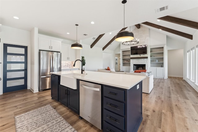 959 County Road 1300, Bridgeport, TX 76426 - kitchen with appliances with stainless steel finishes, a sink, white cabinetry, light countertops, and light wood-style floors