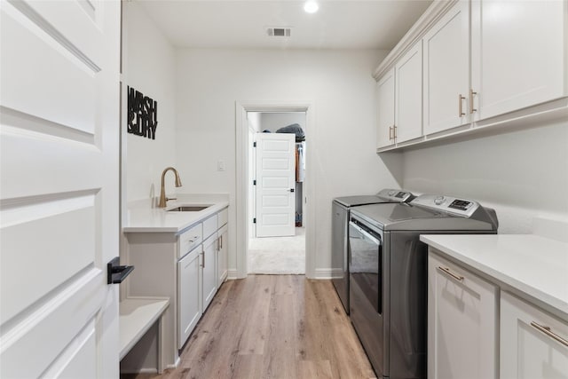 959 County Road 1300, Bridgeport, TX 76426 - clothes washing area with cabinet space, separate washer and dryer, light wood-type flooring, and recessed lighting