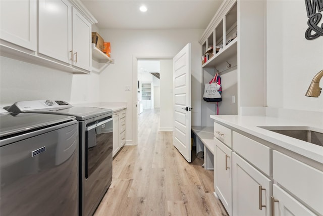 959 County Road 1300, Bridgeport, TX 76426 - laundry room featuring washer and clothes dryer, light wood-type flooring, cabinet space, and recessed lighting