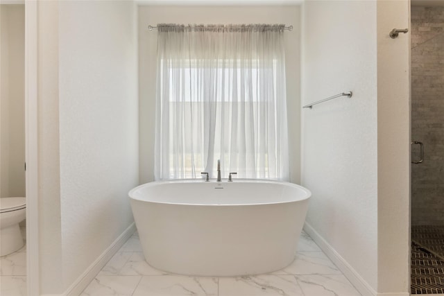 959 County Road 1300, Bridgeport, TX 76426 - full bathroom with marble finish floors, baseboards, a freestanding bath, toilet, and a shower stall