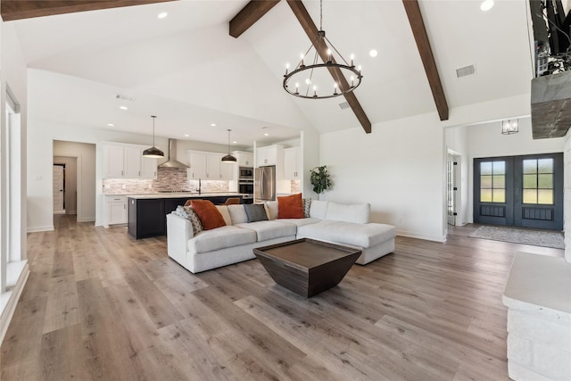 959 County Road 1300, Bridgeport, TX 76426 - living room with high vaulted ceiling, a chandelier, beam ceiling, light wood-type flooring, and french doors