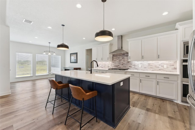 959 County Road 1300, Bridgeport, TX 76426 - kitchen featuring wall chimney exhaust hood, decorative backsplash, light countertops, white cabinetry, and recessed lighting