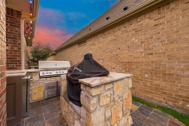 2132 Portwood Way, Fort Worth, TX 76179 - patio terrace at dusk featuring a grill and exterior kitchen