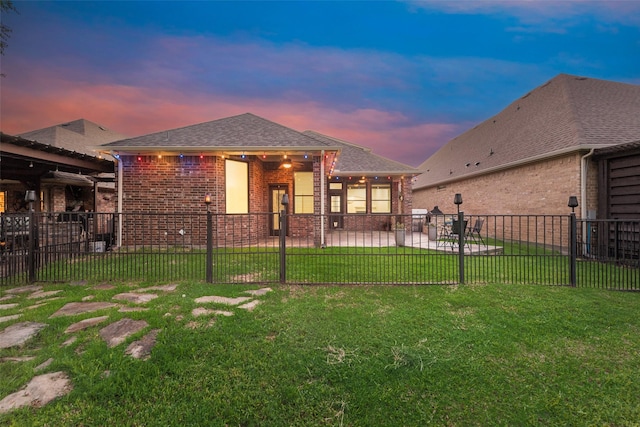 2132 Portwood Way, Fort Worth, TX 76179 - back of property at dusk featuring brick siding, a patio, and a shingled roof