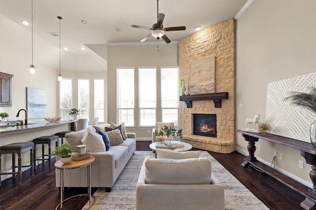 2886 Nottingham Dr, Trophy Club, TX 76262 - living room with a ceiling fan, a stone fireplace, dark wood-type flooring, crown molding, and baseboards