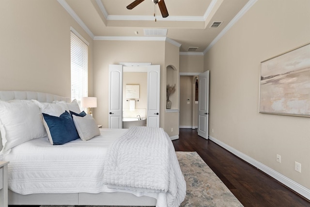 2886 Nottingham Dr, Trophy Club, TX 76262 - bedroom with dark wood-style floors, crown molding, baseboards, ensuite bath, and a raised ceiling