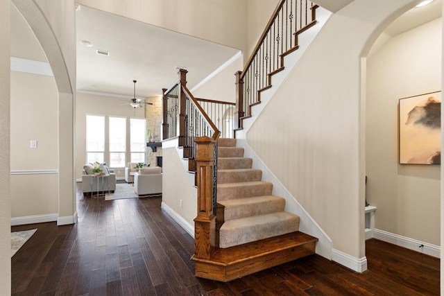 2886 Nottingham Dr, Trophy Club, TX 76262 - entryway featuring arched walkways, a ceiling fan, dark wood-style floors, and crown molding