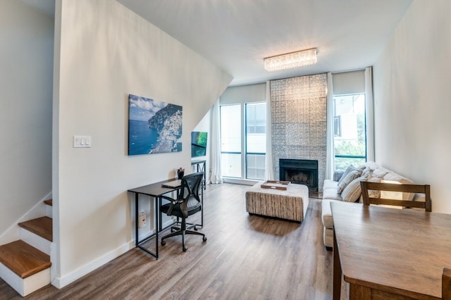 3907 Throckmorton St Unit 4, Dallas, TX 75219 - home office with wood finished floors, a fireplace, and baseboards