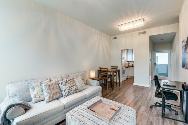 3907 Throckmorton St Unit 4, Dallas, TX 75219 - living room with wood finished floors, an office area, and baseboards