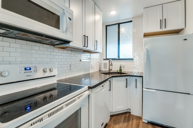 3907 Throckmorton St Unit 4, Dallas, TX 75219 - kitchen with white appliances, a sink, decorative backsplash, dark wood-style floors, and white cabinetry